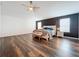 Bright and airy main bedroom featuring dark accent wall, ceiling fan, and hardwood floors at 1706 Leatherback Ln, St Cloud, FL 34771