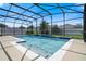 Private swimming pool and enclosure featuring multiple water features and landscaping at 1706 Leatherback Ln, St Cloud, FL 34771