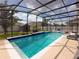 Gorgeous screened-in pool with sparkling water and sun loungers on the patio, perfect for relaxation and entertaining at 1706 Leatherback Ln, St Cloud, FL 34771