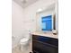 Powder room featuring a toilet, dark wood vanity, and a mirror at 1706 Leatherback Ln, St Cloud, FL 34771