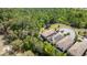 Aerial view of townhomes with pools, solar panels, and tile roofs surrounded by lush greenery at 1801 Nice Ct, Kissimmee, FL 34747