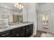 Bathroom boasts dual sinks, granite countertop, ample cabinet space, and a door that leads to the pool at 1801 Nice Ct, Kissimmee, FL 34747