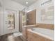 Bathroom features a soaking tub and separate glass enclosed shower with access door to the backyard pool area at 1801 Nice Ct, Kissimmee, FL 34747