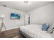 Cozy bedroom with wood-look floors, a wall mounted TV and a comfy bed with pillows at 1801 Nice Ct, Kissimmee, FL 34747