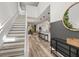 Bright and open entryway with modern staircase and views into the living area at 1801 Nice Ct, Kissimmee, FL 34747