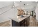 Modern kitchen features a center island with granite countertop, stainless steel sink, and stylish pendant lighting at 1801 Nice Ct, Kissimmee, FL 34747