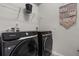 A full-size, black Samsung washer and dryer sit in this laundry room with a shelf and outlets at 1801 Nice Ct, Kissimmee, FL 34747
