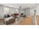Comfortable living room features a large sectional sofa, modern decor, and wood-look floors at 1801 Nice Ct, Kissimmee, FL 34747