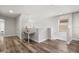Upstairs loft featuring hardwood floors, a work desk, and natural light from a window at 1801 Nice Ct, Kissimmee, FL 34747