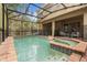 Screened in pool with a spa, patio and string lights creating a relaxing outdoor retreat at 1801 Nice Ct, Kissimmee, FL 34747
