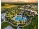 Aerial view of resort with swimming pools, lush landscaping, and comfortable seating areas at 1929 Tropical Palms Cir, Kissimmee, FL 34747