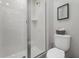 Modern bathroom featuring a glass-enclosed shower, white tile, and contemporary fixtures at 1929 Tropical Palms Cir, Kissimmee, FL 34747