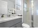 Well-lit bathroom with a modern vanity, walk-in shower with glass door, and neutral decor at 1929 Tropical Palms Cir, Kissimmee, FL 34747