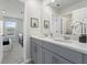 Bright bathroom featuring a double vanity with gray cabinetry and white countertop at 1929 Tropical Palms Cir, Kissimmee, FL 34747