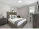 Well-lit bedroom with large upholstered headboard, side tables and modern decor at 1929 Tropical Palms Cir, Kissimmee, FL 34747