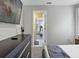 Bright bedroom showcases dresser with TV, and doorway to another bedroom at 1929 Tropical Palms Cir, Kissimmee, FL 34747