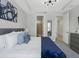 Bedroom with a comfortable bed, tray ceilings, and an ensuite bathroom at 1929 Tropical Palms Cir, Kissimmee, FL 34747