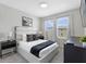Modern bedroom with a plush bed, dark-wood furnishings, and ample natural light from large windows at 1929 Tropical Palms Cir, Kissimmee, FL 34747