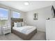 Cozy bedroom with plush carpet, neutral decor, and a large window offering natural light at 1929 Tropical Palms Cir, Kissimmee, FL 34747