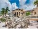 Community clubhouse boasts comfortable seating around a cozy outdoor fire pit with palm tree views at 1929 Tropical Palms Cir, Kissimmee, FL 34747