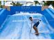 Action shot of the FlowRider at Solara Resort, offering a thrilling surfing experience for all ages at 1929 Tropical Palms Cir, Kissimmee, FL 34747