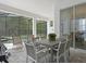 Covered patio with dining and seating area, overlooking the pool area at 1929 Tropical Palms Cir, Kissimmee, FL 34747