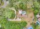 Aerial view of home showing surrounding trees, pool, and driveway at 202 Sweetwater Club Blvd, Longwood, FL 32779