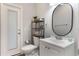 Cozy half-bathroom featuring modern fixtures, stylish vanity, and convenient access to an outdoor space for added functionality at 202 Sweetwater Club Blvd, Longwood, FL 32779