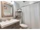 Neutral bathroom with a shower with a white curtain and wood-look vanity and floors at 202 Sweetwater Club Blvd, Longwood, FL 32779