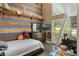 Bedroom featuring a striped accent wall, loft ladder, and natural light at 202 Sweetwater Club Blvd, Longwood, FL 32779