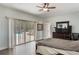 Large bedroom featuring a sliding door with pool views, neutral walls and wood-look floors at 202 Sweetwater Club Blvd, Longwood, FL 32779