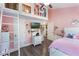 Bedroom featuring a loft and access ladder, pink walls, and plush decor at 202 Sweetwater Club Blvd, Longwood, FL 32779