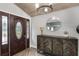 Elegant entryway featuring a decorative front door, stylish console table, and modern lighting at 202 Sweetwater Club Blvd, Longwood, FL 32779