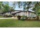 Striking two-story home with stone accents, manicured landscaping, and a welcoming driveway at 202 Sweetwater Club Blvd, Longwood, FL 32779