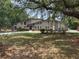 Attractive home featuring a manicured front yard, stone details, and a welcoming entrance at 202 Sweetwater Club Blvd, Longwood, FL 32779