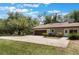 Spacious three car garage with driveway, beautiful lawns, and lush landscaping at 202 Sweetwater Club Blvd, Longwood, FL 32779