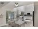 Eat-in kitchen features white cabinets, stainless appliances, granite countertops, and modern fixtures with a view to an outdoor space at 202 Sweetwater Club Blvd, Longwood, FL 32779