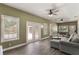 Spacious living room featuring windows and double doors with wood-look floors at 202 Sweetwater Club Blvd, Longwood, FL 32779