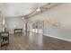 Open living room with vaulted ceiling, luxury vinyl floors, and sliding glass doors to the pool area at 202 Sweetwater Club Blvd, Longwood, FL 32779