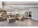 Bright and airy living room showcasing exposed beam ceilings, wood flooring and access to other rooms at 202 Sweetwater Club Blvd, Longwood, FL 32779