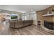Spacious Gathering room with wood floors, decorative fireplace, and large TV at 202 Sweetwater Club Blvd, Longwood, FL 32779