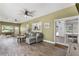 Spacious living room featuring luxury vinyl floors, large window, and patio access at 202 Sweetwater Club Blvd, Longwood, FL 32779