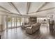 Inviting living room featuring wood flooring, large sliding doors to pool, and open concept to kitchen at 202 Sweetwater Club Blvd, Longwood, FL 32779
