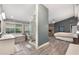 Open concept main bedroom features stone fireplace, tub, shower, dual vanity, and wood grain floors at 202 Sweetwater Club Blvd, Longwood, FL 32779