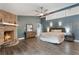 Spacious primary bedroom with a fireplace, ceiling fan, and ensuite bath for a relaxing retreat at 202 Sweetwater Club Blvd, Longwood, FL 32779