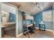 Bright office space featuring a wood ceiling, blue accent wall, ladder bookshelf, and natural light at 202 Sweetwater Club Blvd, Longwood, FL 32779