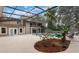A screened-in pool with a garden in the background at 202 Sweetwater Club Blvd, Longwood, FL 32779