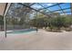 An inviting screen enclosed swimming pool with a large patio area and lush landscaping at 202 Sweetwater Club Blvd, Longwood, FL 32779