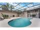 The screened-in pool includes a second-story balcony and lush landscaping at 202 Sweetwater Club Blvd, Longwood, FL 32779
