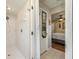 Modern white-tiled shower with a rainfall shower head, complemented by the view into the Primary bedroom at 208 Madeira Ave, Orlando, FL 32825